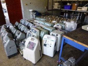 All broken oxygen concentrators--you can see multiple brands in this picture alone. Most of these devices have the same broken component or missing filter, but there is no materials with which to replace these parts.